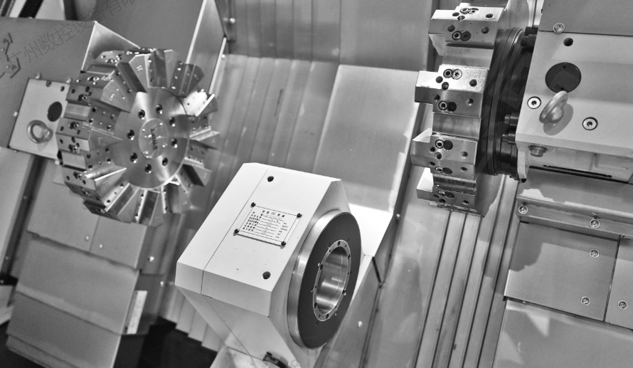 double-head CNC lathe with a tool turret, spindle, and precision metal parts.